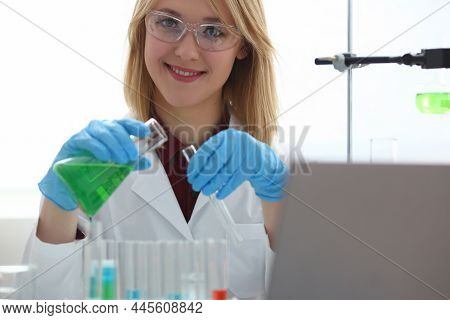Scientist Holds Bottle With Sample With Toxic Green Liquid In Hands In Protective Gloves. Toxic Subs