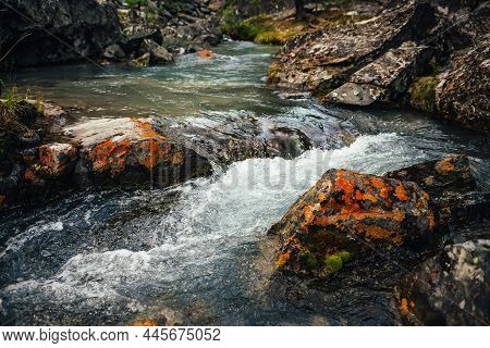 Scenic Nature Background Of Turquoise Clear Water Stream Among Rocks With Mosses And Lichens. Atmosp