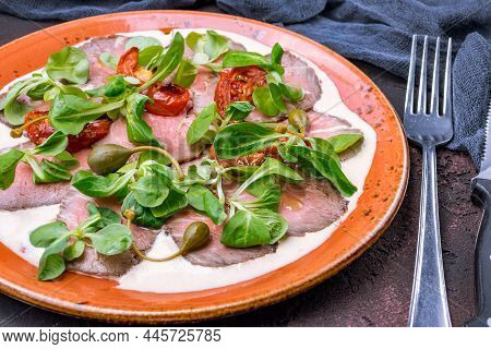 Vitello Tonato On A Plate On Dark Stone Table