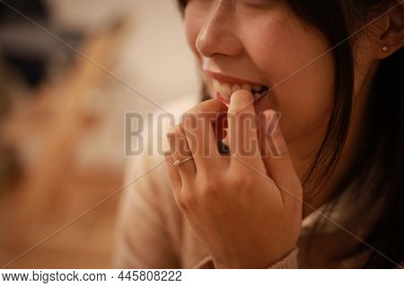 Image Of A Woman Biting Her Nails