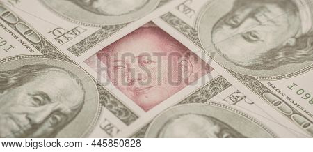 Yuan Banknote, Surrounded By 100 Dollar Bills. American Market Protectionism Concept