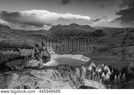 Black And White Epic Aerial Drone Landscape Image Of Sunrise From Blea Tarn In Lake District During 