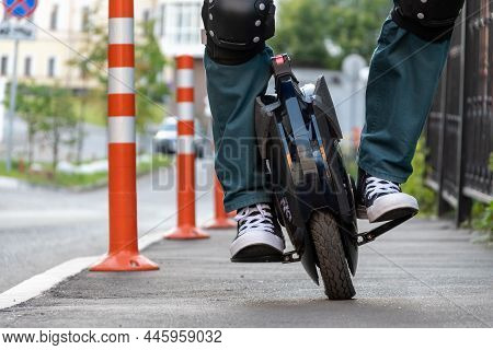 The Legs Of A Young Woman Ready To Ride An Electric Unicycle, Abbreviated Euc. An Unrecognizable Wom