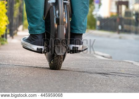 Rider\'s Legs In Protective Gear On An Electric Unicycle (euc). Driving Around The City On An Electr