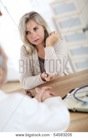 Patient consulting doctor for elbow pain
