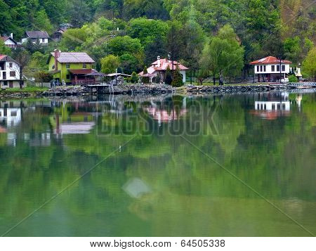 Buildings and trees reflected in water