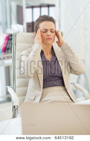 Portrait Of Business Woman With Head Ache In Office