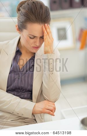 Stressed Business Woman With Head Ache At Work