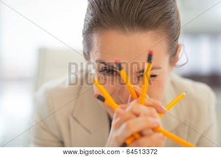 Portrait Of Business Woman Holding Pencils