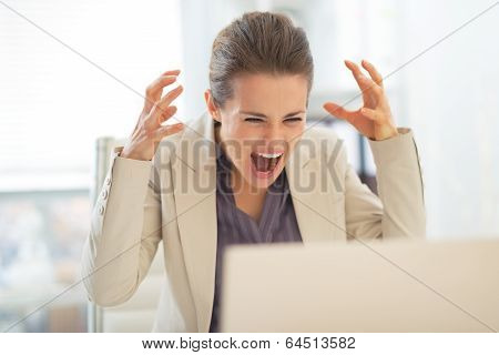 Stressed Business Woman With Laptop At Work