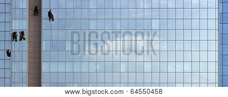 Men cleaning windows on a corporate bouilding