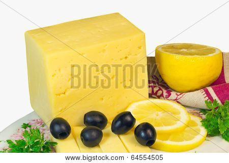 Big Piece Of Cheese, Lemon And Olives On A White Background.