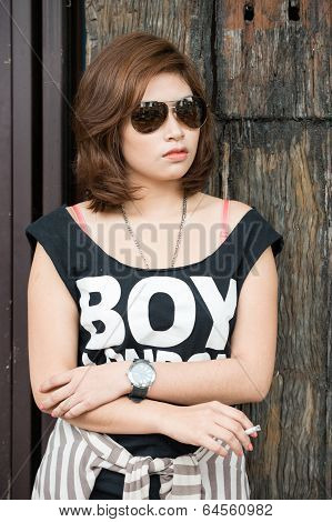 Young Asian Woman Smoking the Cigarette outside