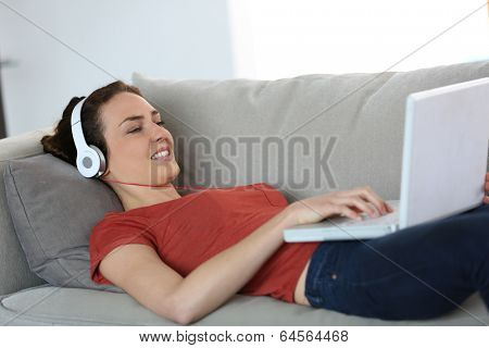 Woman with headphones chating on internet
