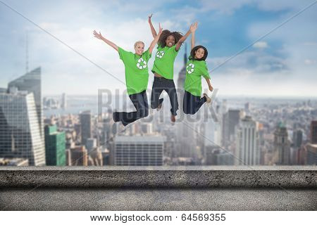 Enviromental activists jumping and smiling against balcony overlooking city