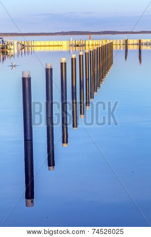 Sunset In Zinnowitz With Reflection On The Water Of The Harbor