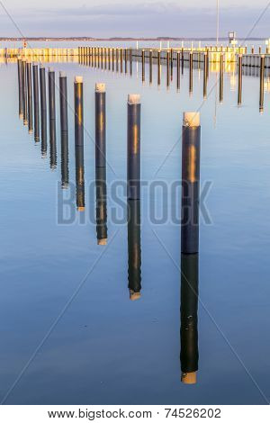Sunset In Zinnowitz With Reflection On The Water Of The Harbor