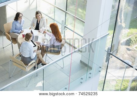 High angle view of businesswomen discussing at table in office
