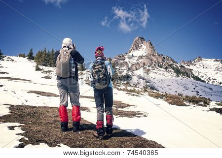 Tourists on a snowy mountain on grungy background