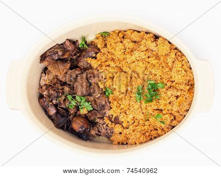 turkish roast lamb, kuzu tandir, with bulgur pilaf in a serving bowl, closeup
