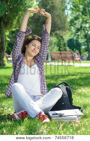 Woman Is Sitting On The Grass