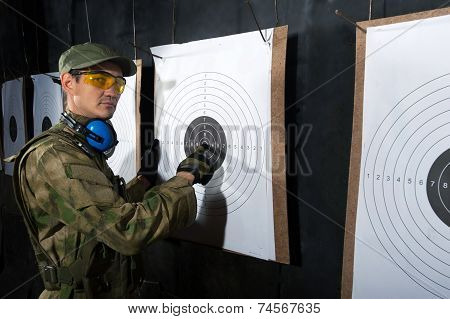 Man with target in shooting range
