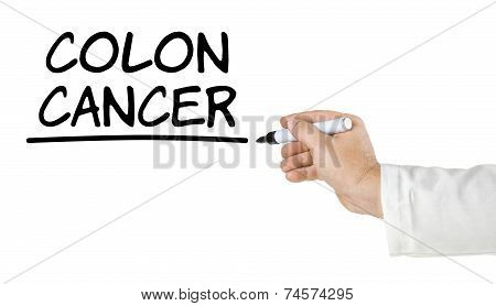 A hand with pen writing Colon Cancer