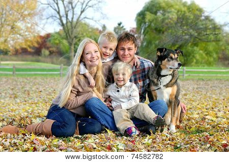 Happy Family And Pet Dog Autumn Portrait