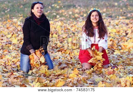 Happy Girl Relaxing On Yellow Autumn Leaves