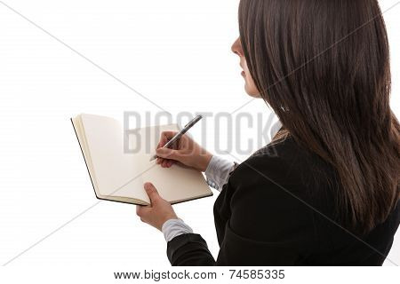Young businesswoman writing in notebook