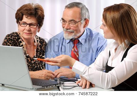 Senior couple meeting with agent or advisor