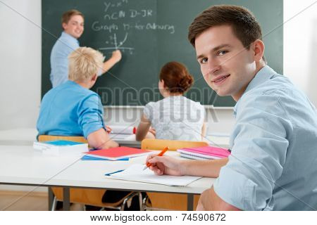 group of students  while studying in classroom