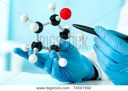 hands of scientist with a molecular structure at the lab