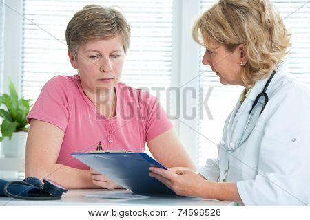 physician discusses test results with her female patient