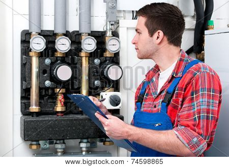 Technician servicing the gas boiler for hot water and heating