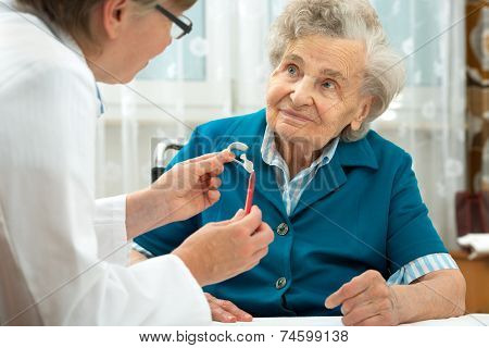 Deaf senior woman during a hearing test