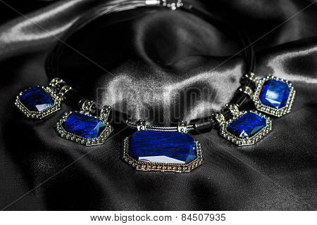 Necklace With Blue Stones On Silk Background