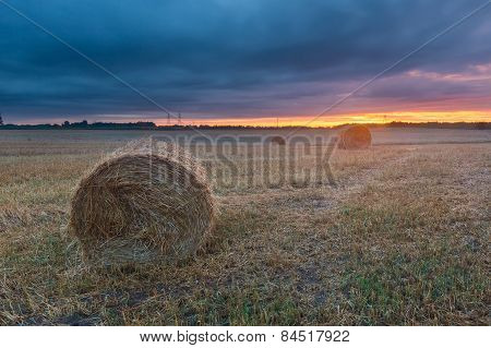 Straw Bales On Field Against Sky