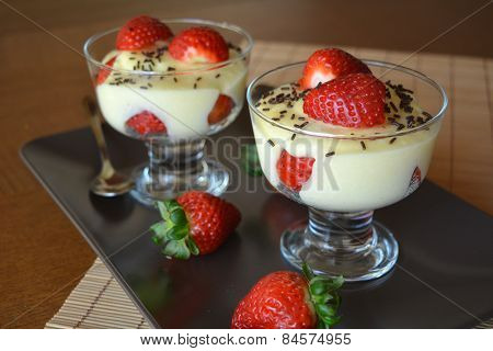 Dessert vanilla pudding with fresh strawberries