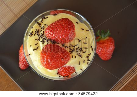 Dessert vanilla pudding with fresh strawberries
