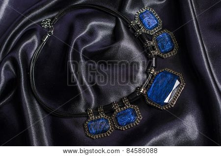 Necklace With Blue Stones On Silk Background