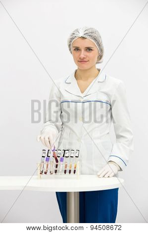 Doctor in uniform with test blood tubes