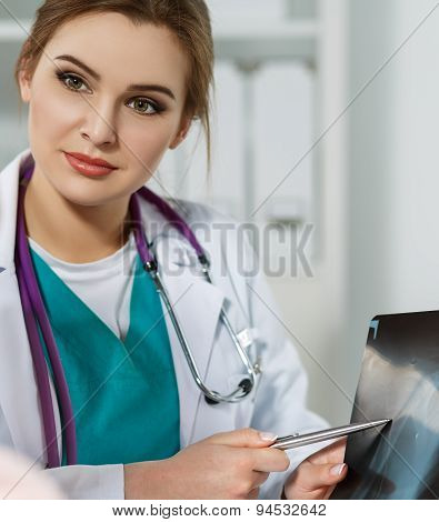 Female Medicine Doctor Pointing To X-ray Picture