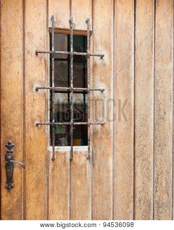Closed Door With Barred Window.