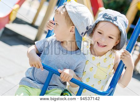 Happy Little Kids On A Swing