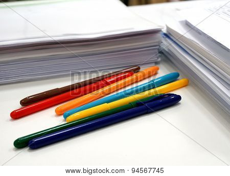 Colorful  Pens  And Documets On The Table