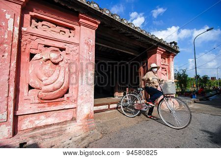 Woman Ride Bicycle At Japanese Bridge, Hoi An
