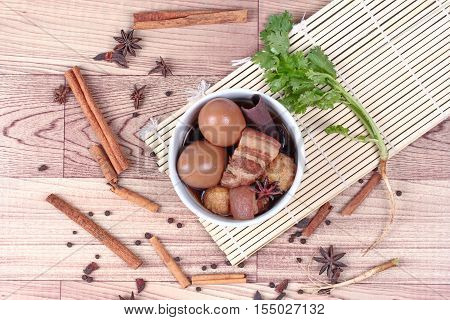 Thai Recipes : Stewed boiled egg with tofu and streaky pork ,call Khai Palo in Thai, take photo with herbs as Chinese star anise ,cinnamon,black pepper,cilantro roots and stems