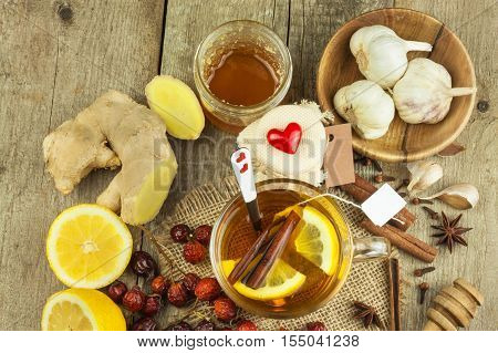 Natural treatment for colds and flu. Ginger lemon honey garlic and rosehip tea against influenza. Hot tea for colds. Home Pharmacy. Proven treatment of diseases. Folk medicine.