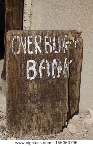 Rhyolite Nevada USA - August 24 2016: Old and broken Overbury Bank sign at the ghost town of Rhyolite